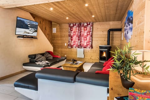 Cosy lounge with stove and sofas in Chalet Snow Angel in le Bettaix