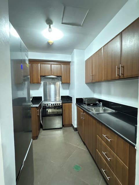 Standard Apartment, 3 Bedrooms | Private kitchen | Fridge, microwave, stovetop, cleaning supplies