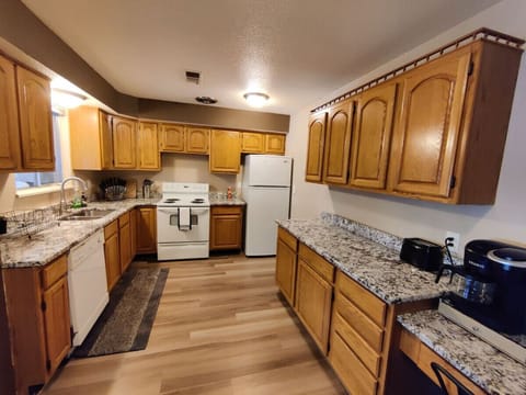 This large kitchen offers ample counter space to fulfill all your meal preparation needs.There is a cozy work space on the side.