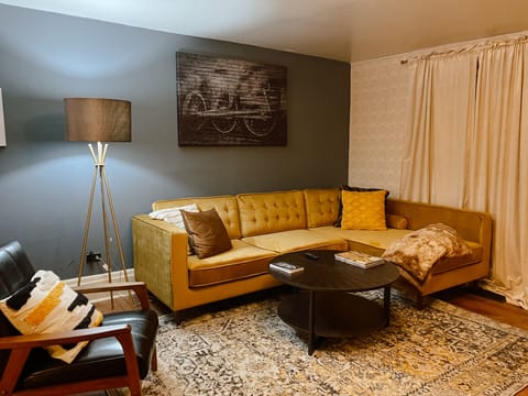 Spacious living room area with cozy sofa, perfect for family or friends reunion