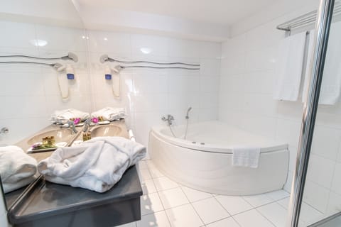 Suite, Jetted Tub | Bathroom | Combined shower/tub, hair dryer, bathrobes, slippers