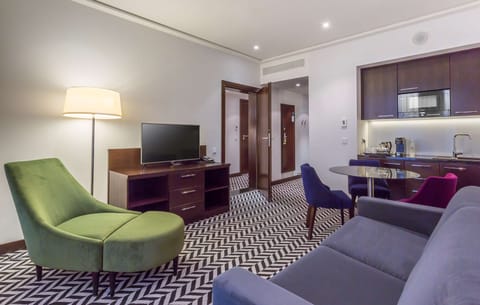 Suite, 1 Bedroom | Living area | 55-inch flat-screen TV with cable channels, TV