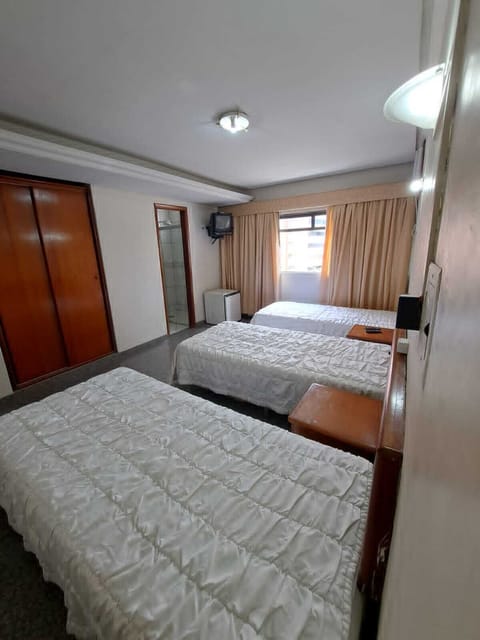 Economy Triple Room | Desk, bed sheets