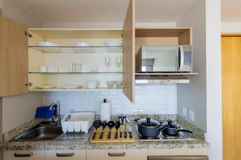 Fully equipped kitchen with appliances and utensils