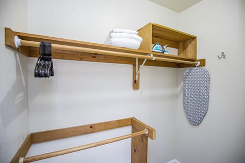 Primary closet, iron & ironing board for guest use. 