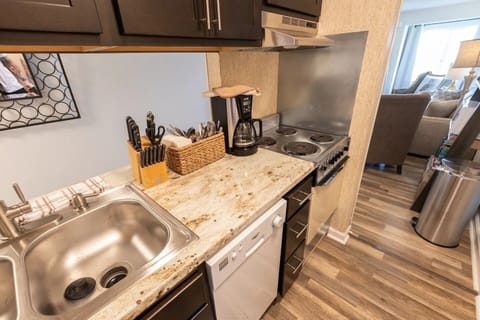 The kitchen comes with dishes, silverware, cooking pans, and a coffee maker.