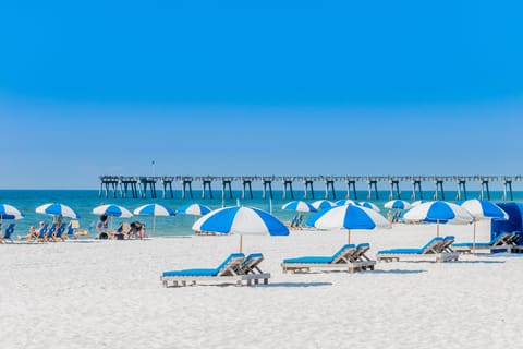 On the beach, white sand, beach cabanas, beach umbrellas