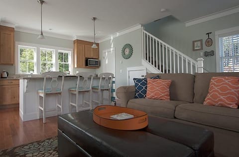 Upgraded kitchen opens to a spacious living area centered around a cozy fireplace