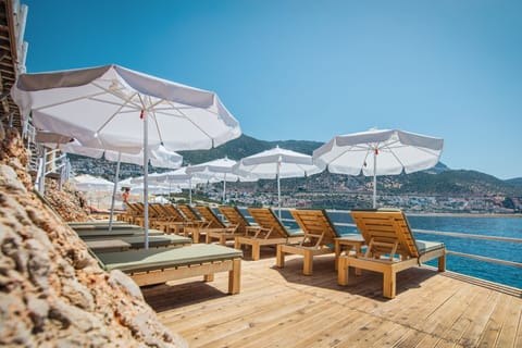 Private beach, black sand, sun loungers, beach umbrellas