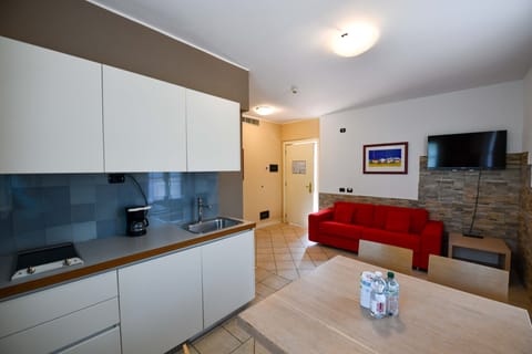 Deluxe Apartment | Living area | 32-inch flat-screen TV with satellite channels, TV