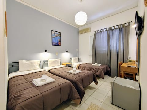 Triple Room | Minibar, desk, iron/ironing board, free WiFi