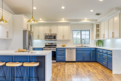 Spacious kitchen in the main house features an open layout with modern appliances and barstool seating.