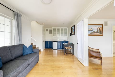 Additional lounge space on the lower level features a couch and kitchenette.