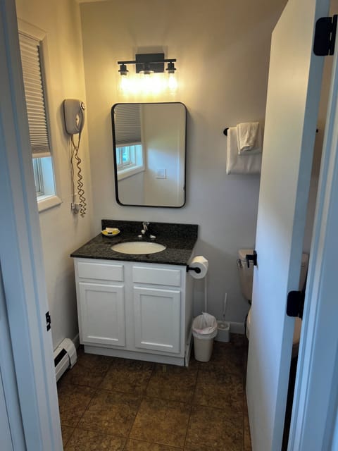 Deluxe Efficiency, 2 Queen Beds, Fireplace | Bathroom | Combined shower/tub, free toiletries, hair dryer, towels