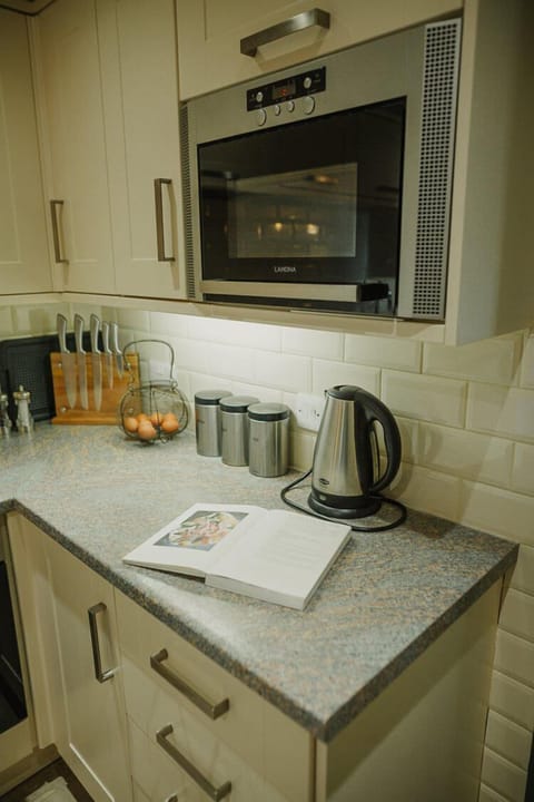 Ground floor: Open plan kitchen with oven, 4 ring hob, fridge, freezer, microwave & dishwasher