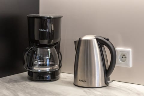 A coffee station with a coffee maker and electric kettle, ensuring guest convenience.