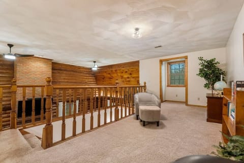 loft area with seating an small television to play video games. 