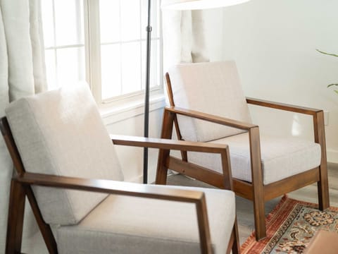 Two inviting armchairs, perfect for a moment of peace. The subtle textures and warm lighting evoke a sense of calm.