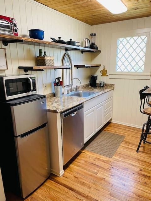 Kitchen complete with dishwasher, garbage disposal, microwave, refrigerator, Keurig, toaster oven, single burner hot plate, hot water kettle, blender, dishes, pots & pans & utensils
