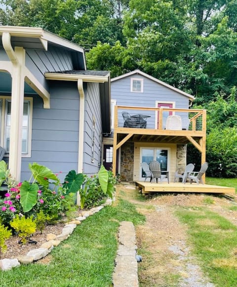 View of upper deck from gravel driveway. Walking path to left side of bottom deck leads to stairs up to this unit