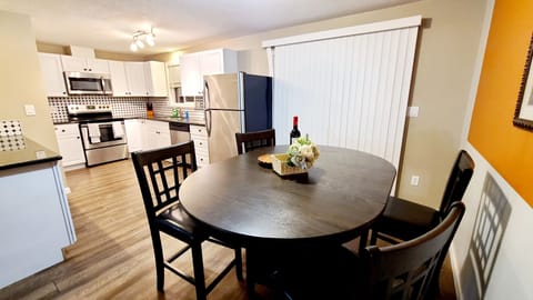 Dining table has 4 chairs. 2 stools next to counter to seat 6.
