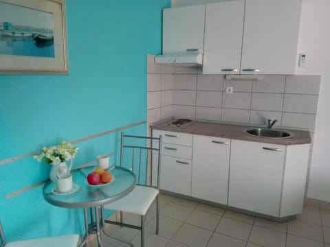 Studio (Studio with Balcony) | Private kitchen | Fridge, dining tables