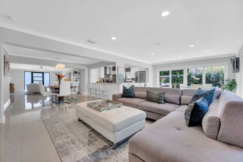 The comfy living room includes a large smart TV, direct access to the outdoor oasis, and located next to the breakfast nook.