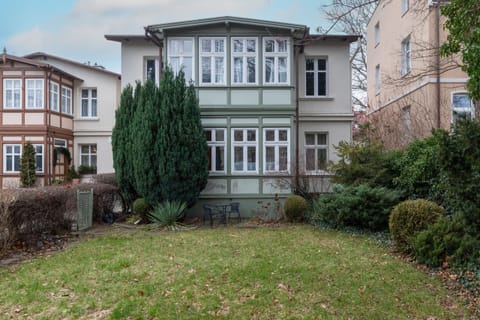 An exterior view of the property, showcasing a well-maintained garden and charming architecture.
