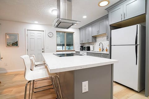 The updated kitchen is well-stocked with all the cookware and utensils needed to prepare meals