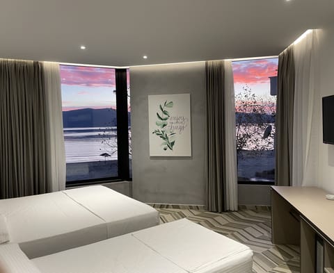 Deluxe Triple Room, Sea View | 1 bedroom, premium bedding, minibar, desk