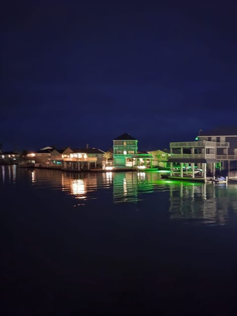 Enjoy the night time lights reflecting on the water.
