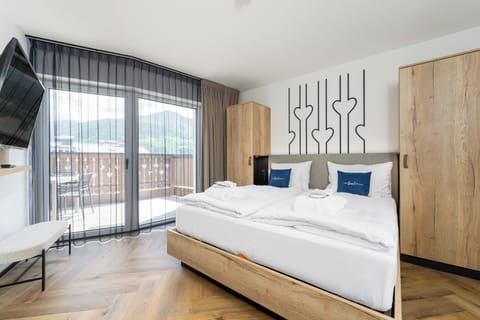 Deluxe Suite, 2 Bedrooms, Sauna | Minibar, in-room safe, desk, iron/ironing board