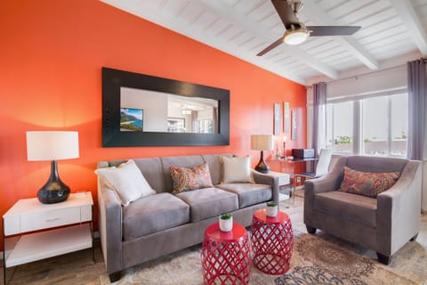 Relax in this lounge area featuring a large couch and a comfortable armchair.