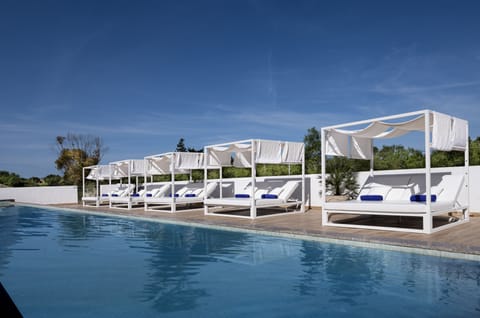 Outdoor pool, open 10:00 AM to 8:00 PM, pool umbrellas