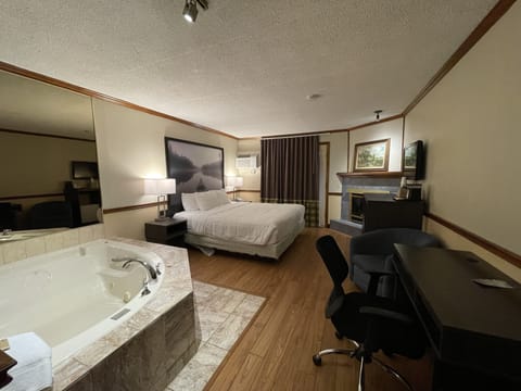 Suite, 1 King Bed, Non Smoking | Desk, laptop workspace, blackout drapes, iron/ironing board