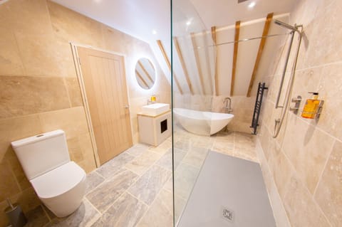 Luxury Room, Courtyard View | Bathroom | Separate tub and shower, deep soaking tub, hair dryer, towels