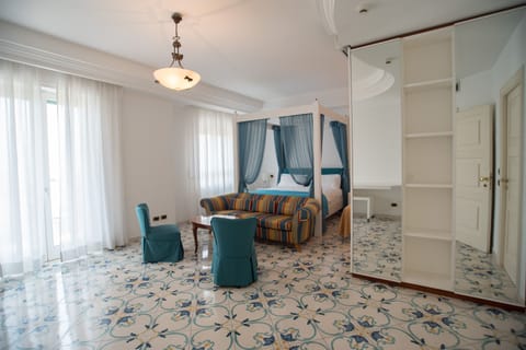 Junior Suite, Partial Sea View | Down comforters, minibar, desk, blackout drapes