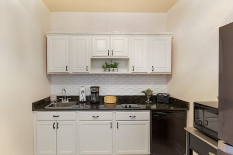 The kitchenette is equipped with granite countertops, a Keurig coffee maker, toaster, microwave, and refrigerator.