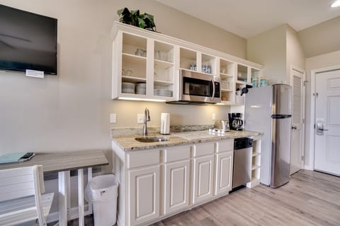 Kitchenette with cook top, fridge and microwave.