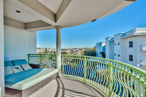 Spacious balcony with oversized lounge chair and extra seating.
