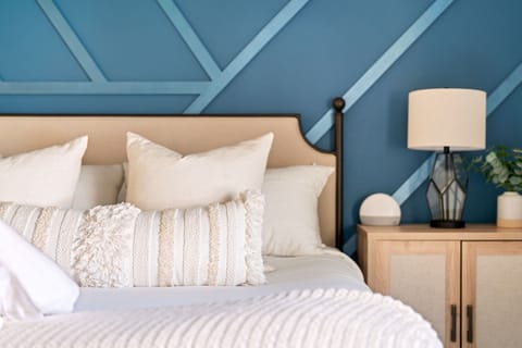 Indulge in the ultimate relaxation in our bedroom, boasting a spacious and inviting bed accompanied by an array of soft and cozy pillows.