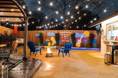 Unwind in a stunning backyard oasis featuring a sparkling pool with a fun duck floatie, cozy string lights, and ample seating. Perfect for evening swims and outdoor relaxation!
