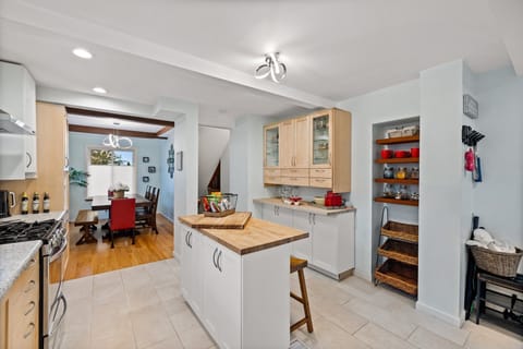 Gather with friends and family around the spacious kitchen island, complete with extra seating that ensures everyone has a place to enjoy culinary delights in this fully stocked kitchen.