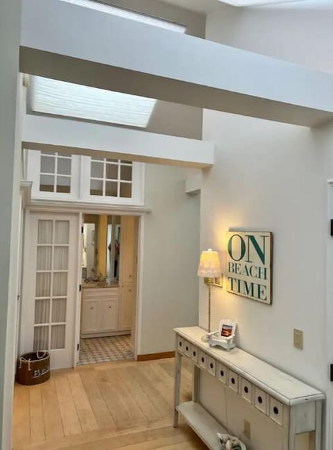 Entry hall view. Entrance to 3/4 guest bathroom in distance. So light 'n bright!