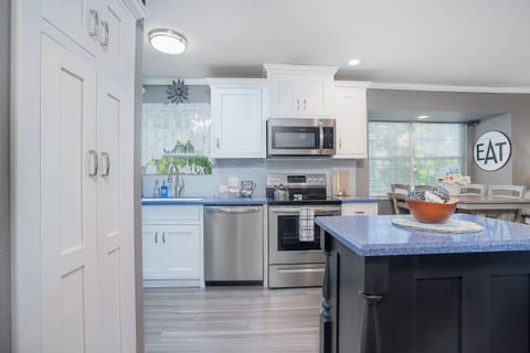 With our spacious kitchen island! The perfect spot to prep meals, enjoy a casual bite, or sip a glass of wine while chatting with friends.