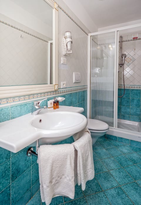 Combined shower/tub, designer toiletries, hair dryer, slippers