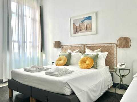 Triple Room, Multiple Beds, Sea View | Minibar, desk, free WiFi, bed sheets