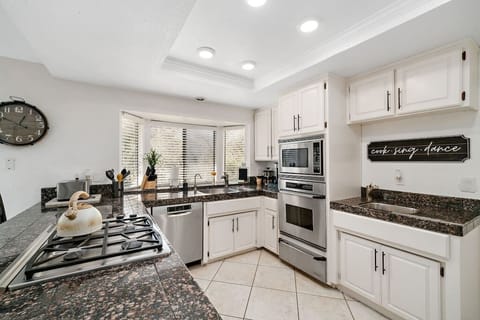 Kitchen with Gas Stove, Microwave, Oven, Toaster, and Coffee Makers