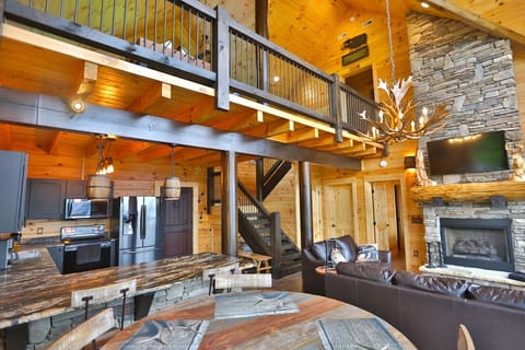 open floor plan opens the kitchen and dining are to views of the fireplace and mountains