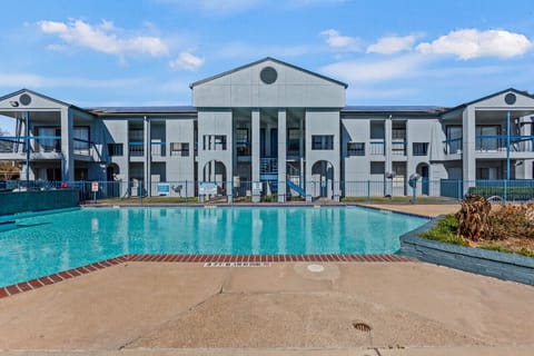 Contemporary apartment building offering prime views of the swimming area.